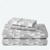 Flannel print sheet set folded and stacked neatly on a white background