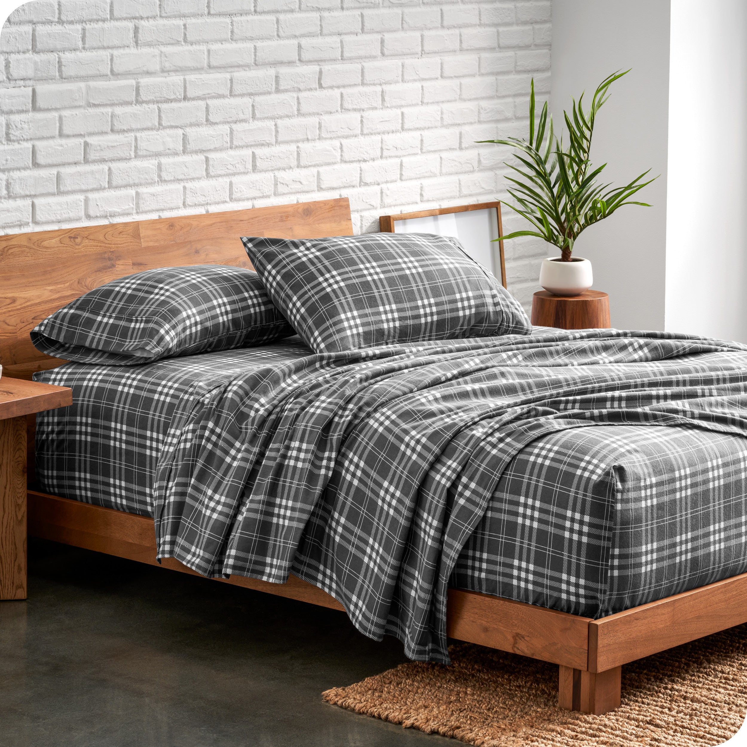 A bed made with printed flannel sheets