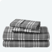 Flannel print sheet set folded and stacked neatly on a white background