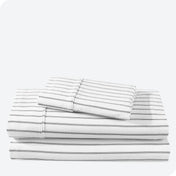 Flannel print sheet set folded and stacked neatly on a white background
