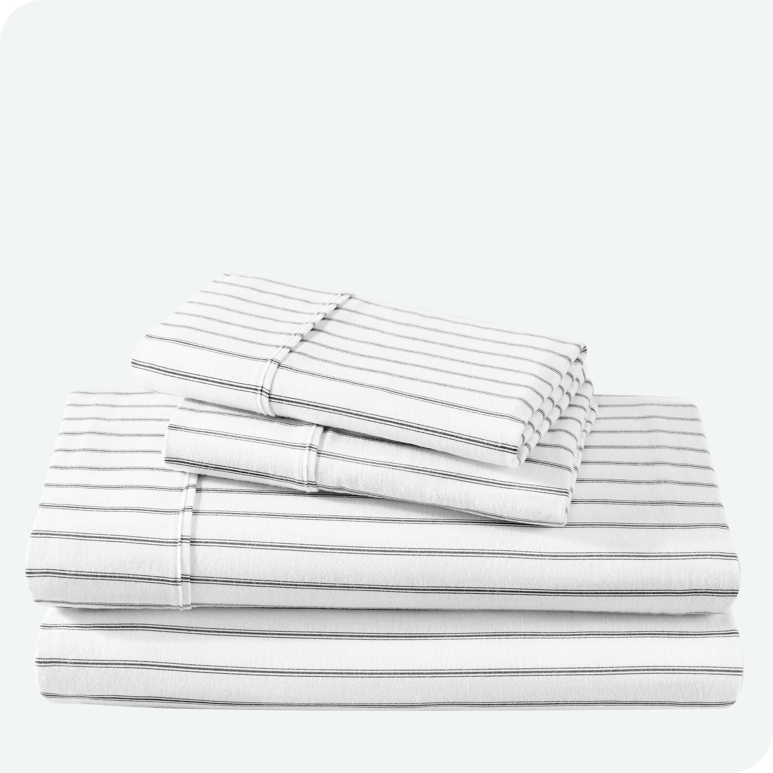 Flannel print sheet set folded and stacked neatly on a white background