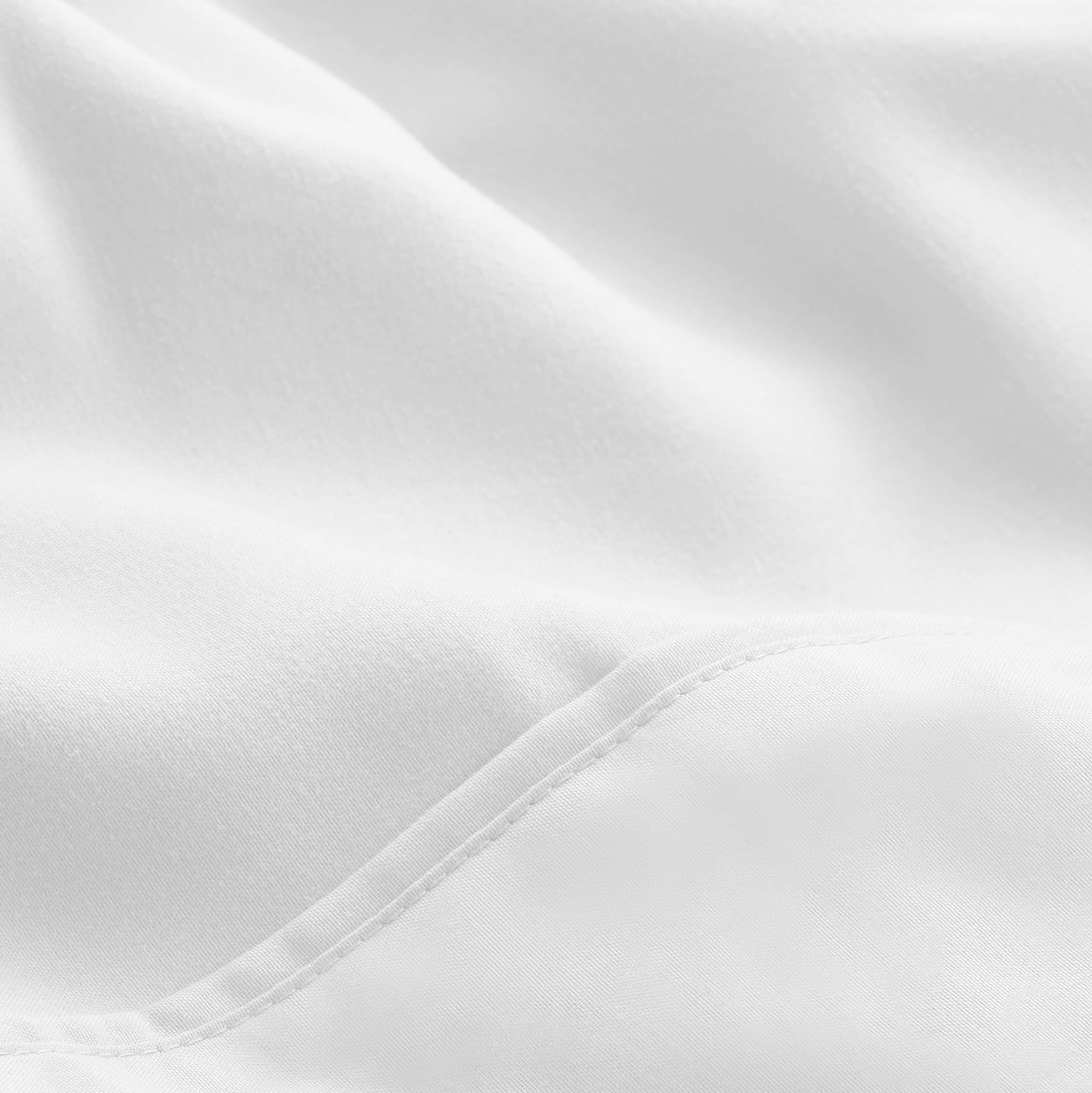 A close up view of a white microfiber bed sheet.