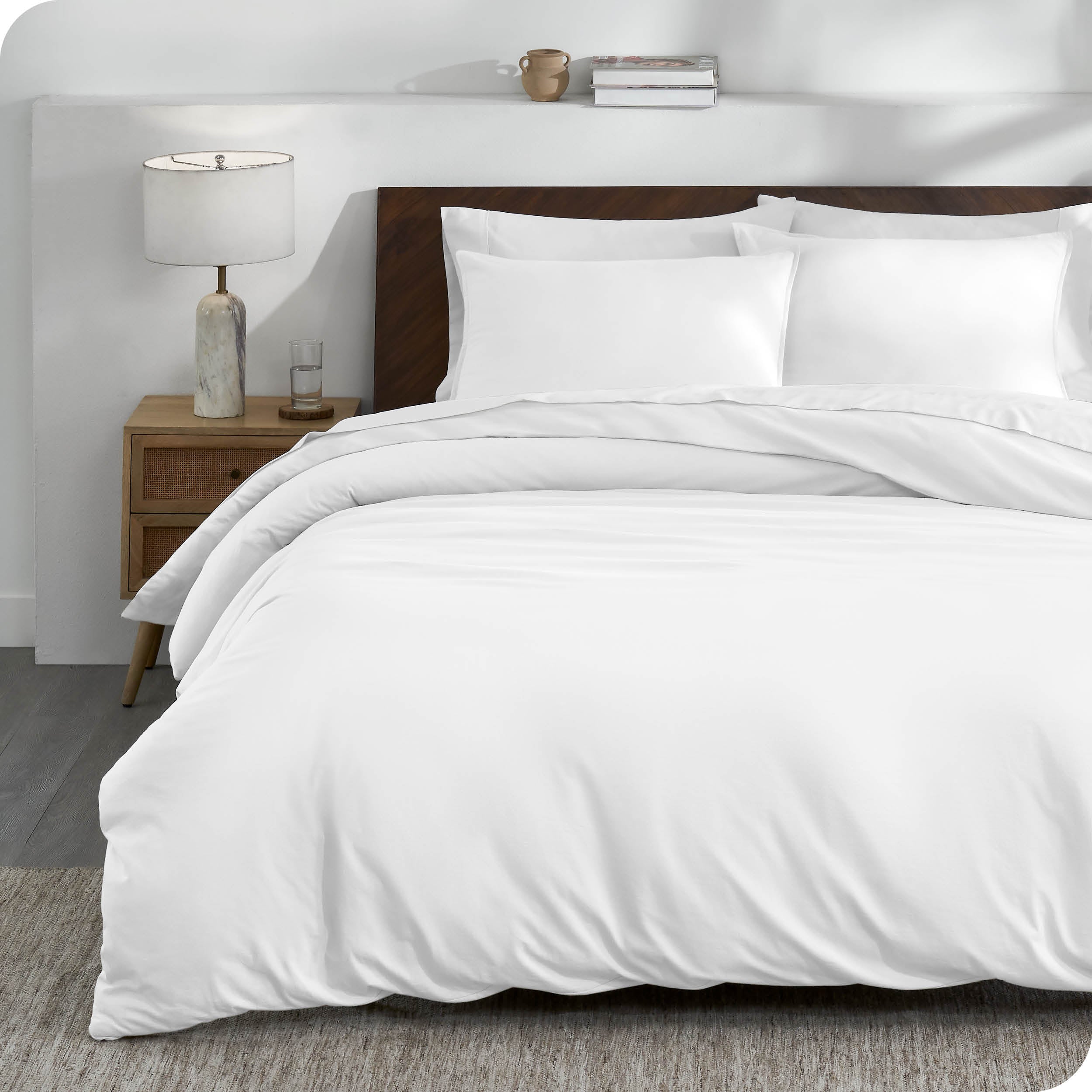 A white organic cotton jersey duvet cover on a bed made with a white bedding