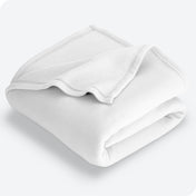 White polar fleece blanket folded with 1 corner folded back