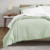 A modern bed with an organic sateen duvet cover set on.