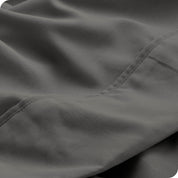 Close up of a grey microfiber sheet showing the stitching and texture