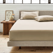 Modern bedroom with bed showing french beige percale fitted sheet