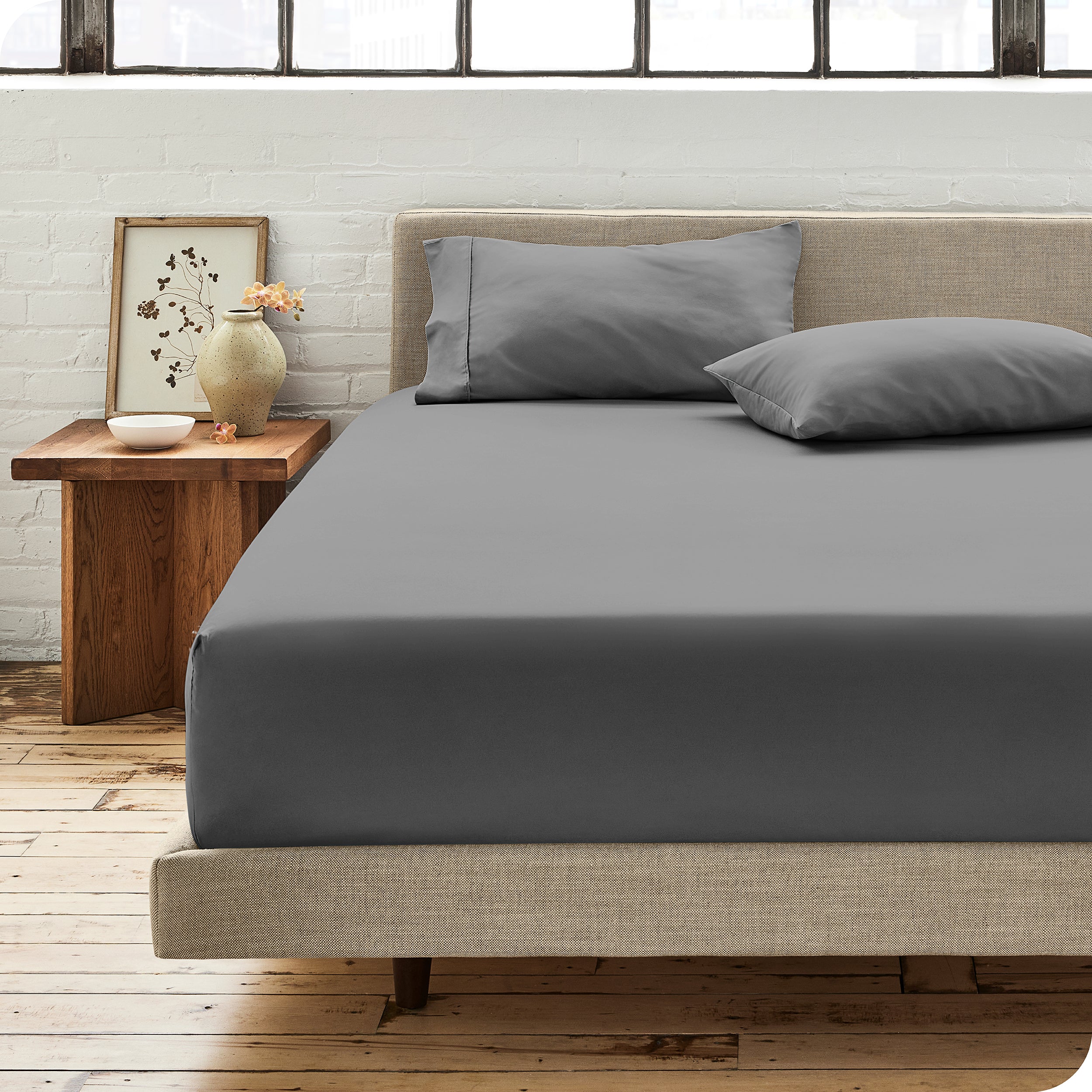 Modern bedroom with bed showing grey percale fitted sheet