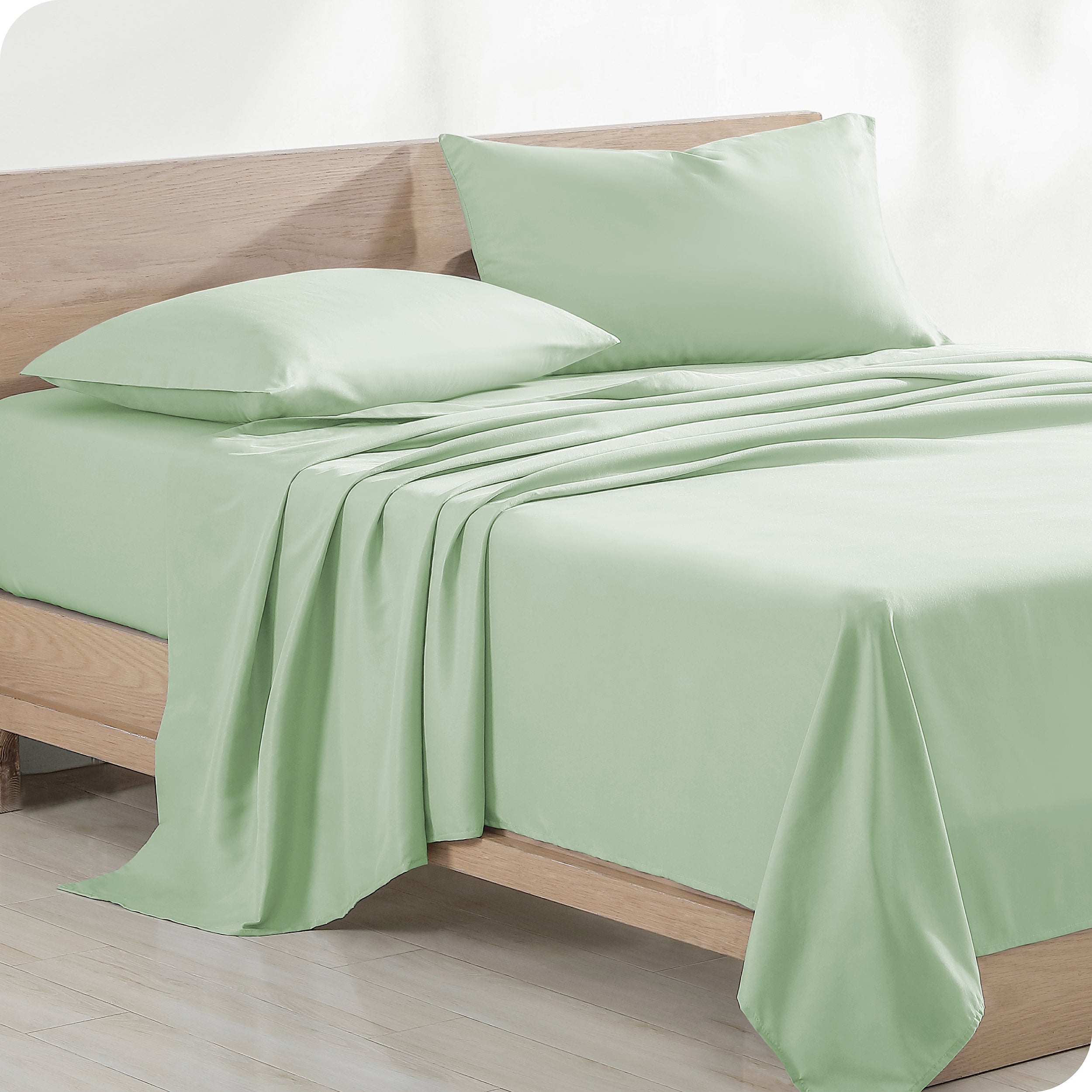 Diagonal view of modern wood bed with sheets and pillows
