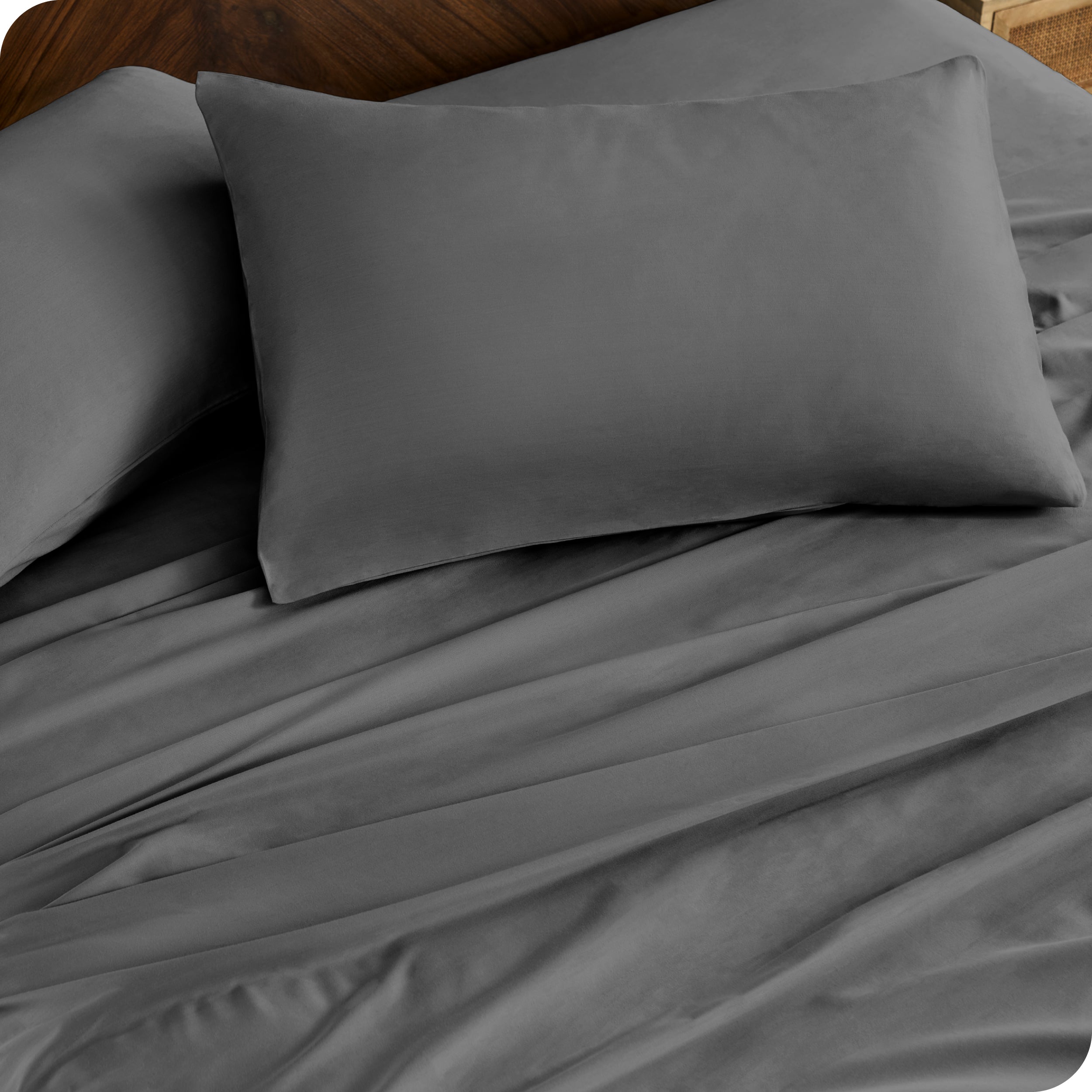 Close up of percale pillowcases and sheets on a bed