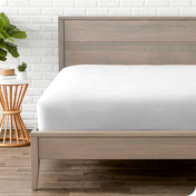 Modern wood bed frame with a sateen fitted sheet on the mattress